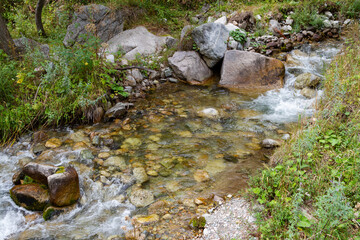Naklejka na ściany i meble large stone in a mountain stream