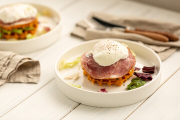 Sweet potato waffles with ham, avocado, lettuce and poached egg