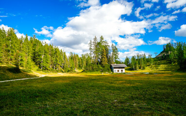 Krallersee on the high plateau of the Tauplitzalm with a small hut. View of the lake at the Totes Gebirge in Styria. Idyllic landscape with green nature and a lake on the Tauplitz.

