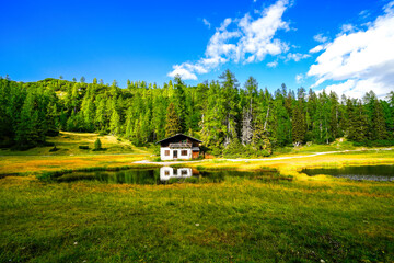 Krallersee on the high plateau of the Tauplitzalm with a small hut. View of the lake at the Totes Gebirge in Styria. Idyllic landscape with green nature and a lake on the Tauplitz.
 - obrazy, fototapety, plakaty