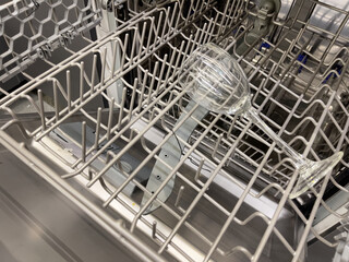 Dishwasher with wine glass, close-up photo.