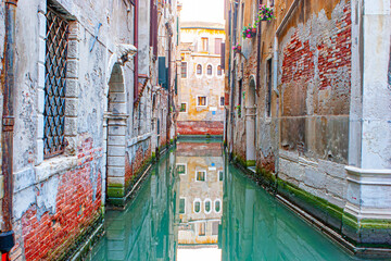 reflectio of old facades in a narrow canal in Venice