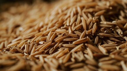 A pile of brown rice sitting on top of a table. Can be used to represent healthy eating, organic food, or cooking