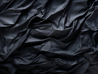 Black crumpled paper abstract texture in low light background