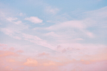A beautiful sky tinted by the sun leaving vibrant shades of gold, pink, blue and multicolored. Clouds in the twilight evening and morning sky. Cloudy sky background in the evening and during the day.