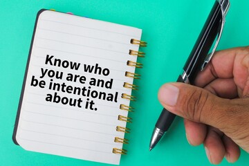 pen and notebook with the words Know who you are and be intentional about it.