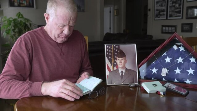 Senior retired military man looking through his passport after a lifetime of service and travel