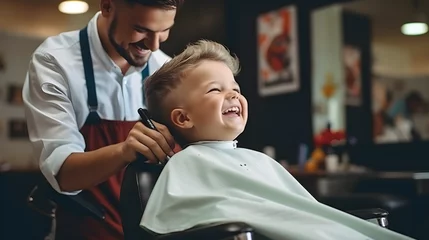 Poster Im Rahmen A little boy gets a haircut from a barber in the salon © Ольга Дорофеева