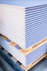 The stack of Special gypsum board with enhanced sound insulation Plasterboard. Panel Type DF for indoor concrete walls prepared for construction