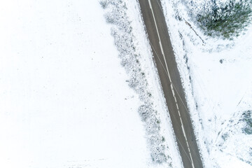 aerial top drone view of a road in a snowy landscape