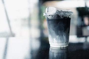 Ice charcoal latte with fresh milk it showing the texture and refreshing look of the drink in...