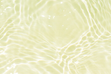 Bluewater waves on the surface ripples blurred. Defocus blurred transparent blue colored clear calm water surface texture with splash and bubbles. Water waves with shining pattern texture background.