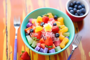 rainbow fruit salad with red strawberries to violet grapes