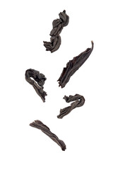 Levitation of dry black tea leaves isolated on a transparent background.