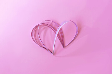 Aesthetic creative pastel pink paper heart with soft light and shadows on pink background, beautiful Valentine day postcard template, love concept