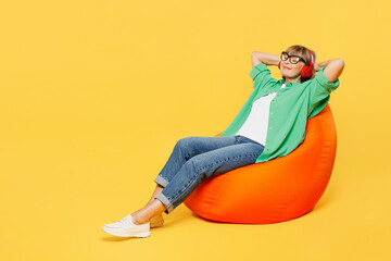 Full body elderly blonde woman 50s years old wear green shirt glasses casual clothes sit in bag...