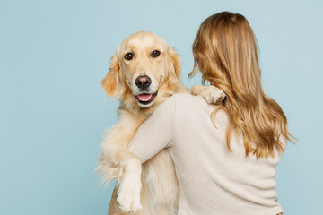 Back rear view young owner blonde woman with her best friend retriever dog she wear casual clothes...