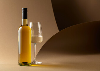 Bottle and glass of white wine.