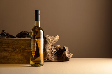 White wine and old snag on a beige background. - obrazy, fototapety, plakaty