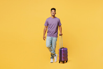 Traveler man he wears summer casual clothes hold bag look aside isolated on plain yellow color background studio. Tourist travel abroad in free spare time rest getaway Air flight trip journey concept