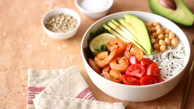 Bowl with rice, shrimp, avocado, tomato, chickpeas and lime. Healthy eating. Diet.