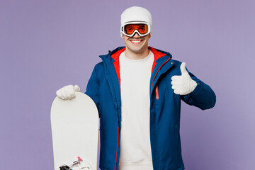 Happy smiling fun cool man he wear warm blue windbreaker jacket ski goggles mask hat hold snowboard...