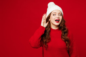 Young curious fun nosy woman she wears knitted sweater white hat casual clothes try to hear you...