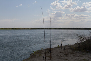 fishing rods on the river bank