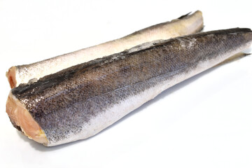 Two carcasses of fresh hake fish lie on a white background.