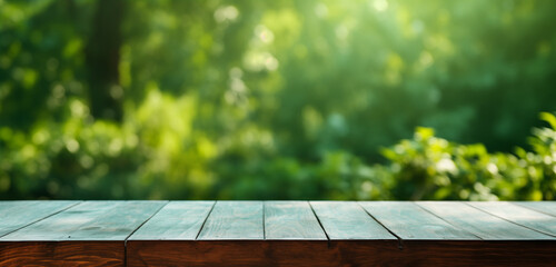 Empty wooden table with jungle, out of focus nature behind, space to place brand, product or advertising - obrazy, fototapety, plakaty
