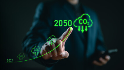Businessman point to increasing arrow with carbon reduction for decrease CO2, carbon footprint and carbon credit to limit global warming from climate change, Bio Circular Green Economy concept.
