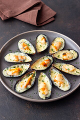 Baked mussels with cheese and herbs. Seafood. Healthy eating.