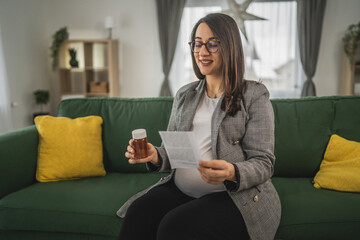 Expectant woman read leaflet take tablets medication or supplement