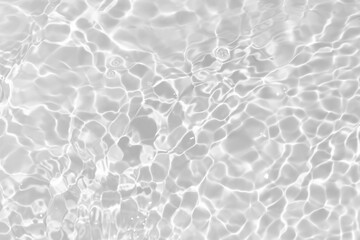 White water with ripples on the surface. Defocus blurred transparent white colored clear calm water surface texture with splashes and bubbles. Water waves with shining pattern texture background.