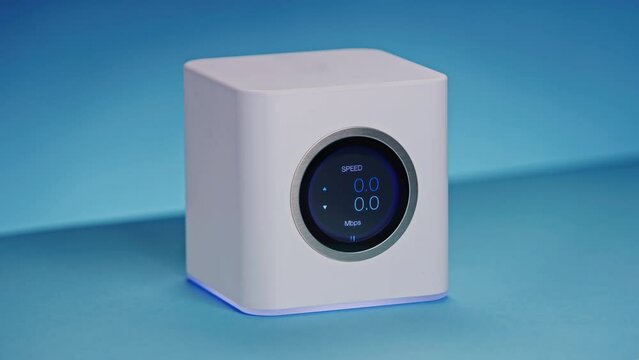 LCD display high end wireless internet wifi router is showing transfer speed in kilobits, megabits per second as data is downloaded in network, data rate first going up and then slowing down to zero