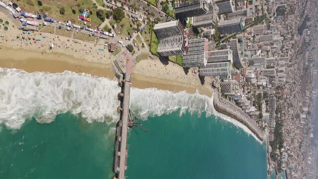 Aerial View Along Acapulco Beach And Vergara Pier In Vina Del Mar With Hotel And Beach Coastline In Background. Vertical Video, Push Forward 