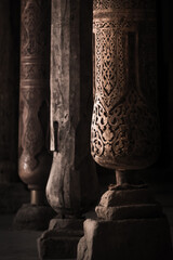 Interior inside the ancient Juma mosque with wooden carved mosaic columns, in the ancient city of Khiva in Khorezm, wood carvings on the columns