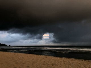The atmosphere was cloudy and black clouds in the sky near the beach
