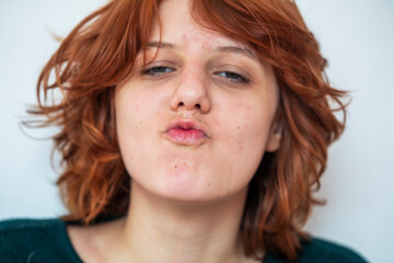  close-up portrait of a pensive teenage girl with red hair with a stylish anime hairstyle