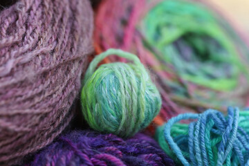 Closeup detail of colourful ball of wool, skeins of organic natural handspun and handdyed merino...