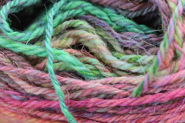 Closeup detail of colourful ball of wool, skeins of organic natural handspun and handdyed merino...