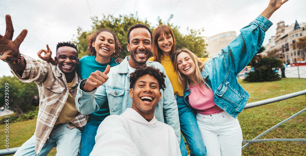 Wall mural multiracial friends taking selfie with smart mobile phone outside - happy young people smiling at ca