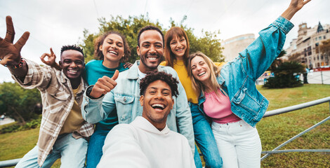 Multiracial friends taking selfie with smart mobile phone outside - Happy young people smiling at...