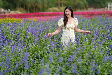 beautiful woman in dress enjoying blooming lavender flower field
