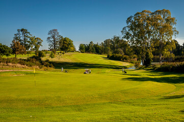 Fototapeta na wymiar Golf course with treelined fairways and mountain views