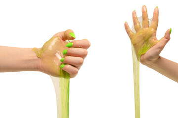 Green slime toy in woman hand with green nails isolated on a white background.