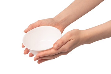 Female hand is holding a ceramic bowl isolated on white background.