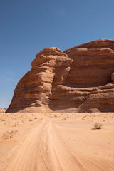 Fototapeta na wymiar A stunning rock formation stands prominently in the vast and barren Wadi Rum desert in Jordan.