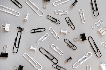 collection of various type of paper clips over grey