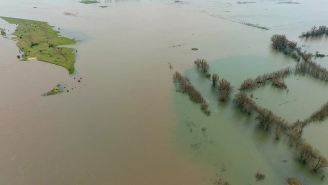 Aerial view of farms and communities flooded along the Waal River near Rotterdam Netherlands as severe storms pummel the area
